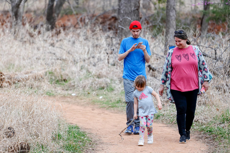 The Brown family walks Wednesday at Martin Park in Oklahoma City.