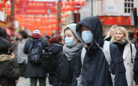 Chinese New Year revellers in London wore face masks to the celebrations amid the coronavirus fears - Credit: Anadolu Agency