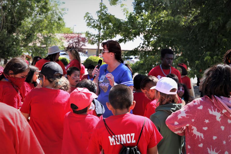 Bloomfield Municipal Schools Superintendent Kim Mizell addresses students in the parking lot of the Bloomfield Wells Fargo location on Thursday, June 29 after they finished painting a mural on the wall at Kare Drug.