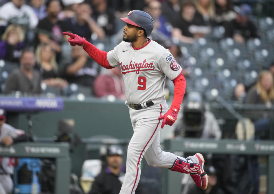 Washington Nationals' Jeimer Candelario points to the dugout as he runs the bases on a solo home run off Colorado Rockies starting pitcher Jose Urena during the first inning of a baseball game Friday, April 7, 2023, in Denver. (AP Photo/David Zalubowski)
