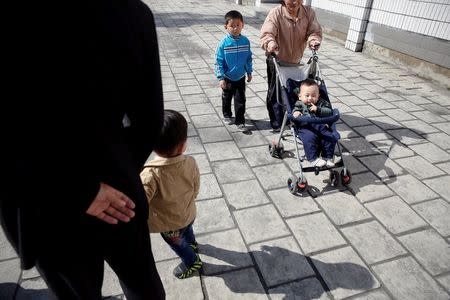 A woman pushes a baby in stroller outside a subway station in central Pyongyang, North Korea May 7, 2016. REUTERS/Damir Sagolj