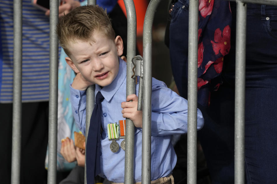 A young boy watches the Anzac Day march in Sydney, Monday, April 25, 2022. Australia and New Zealand commemorate Anzac Day every April 25, the date in 1915 when the Australia and New Zealand Army Corps landed on Turkey in an ill-fated campaign that created the soldiers' first combat of World War I. (AP Photo/Rick Rycroft)