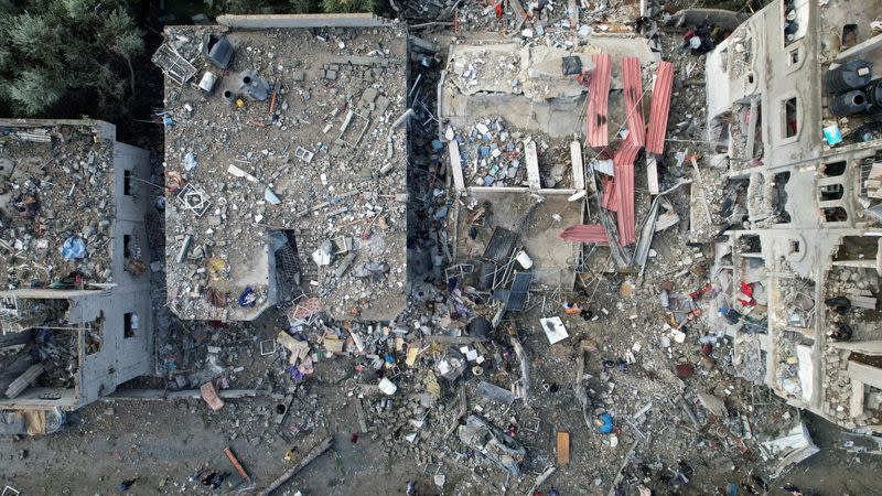 FILE PHOTO: Palestinians gather at the site of Israeli strikes on houses, at the Maghazi camp in the central Gaza Strip