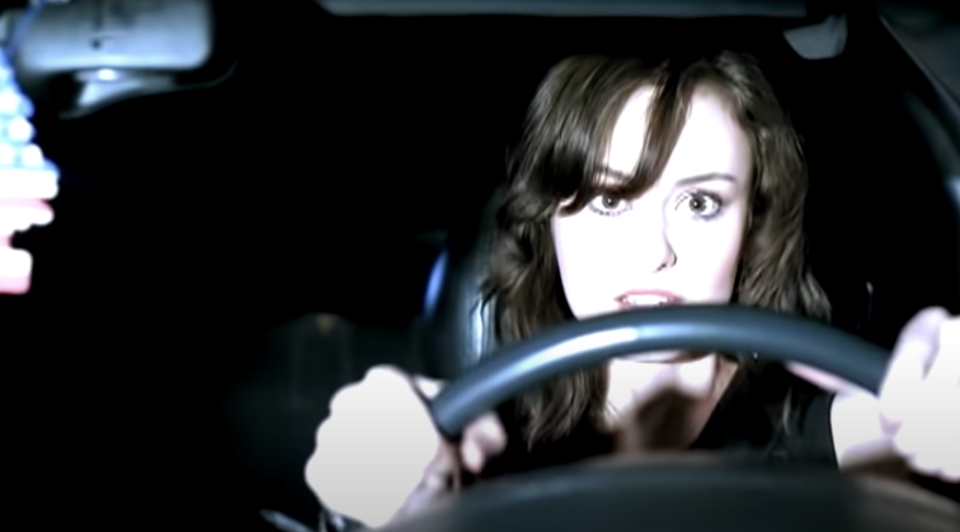 A driver looks helplessly at an oncoming car in Simple Plan's "Untitled" music video