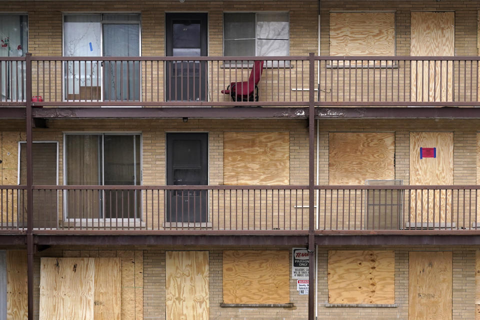 Various apartments at an apartment complex Monday, Jan. 8, 2024, in Harvey, Ill., are boarded up where some are not. (AP Photo/Charles Rex Arbogast)