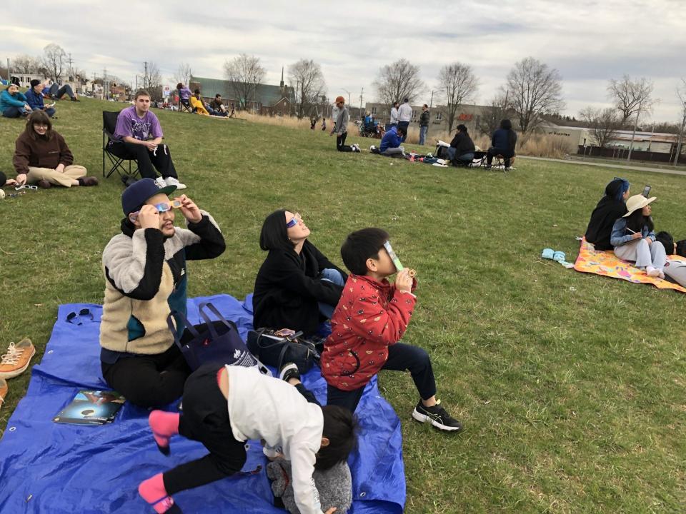 Musashi and Yui Muratami watch the eclipse with their sons Seigi, in center, and Akito at Fort Stanwix National Monument in Rome on April 8, 2024. The family drove up from Cherry Hill, New Jersey.