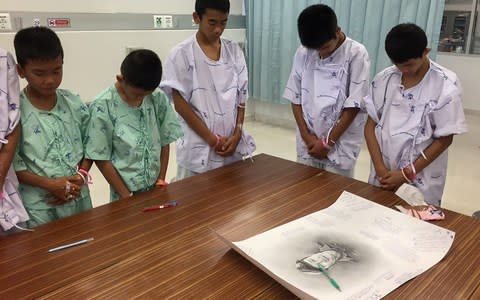 The rescued boys pay tribute to Saman Kunan, who died during the operation to save them - Credit: Reuters/Reuters