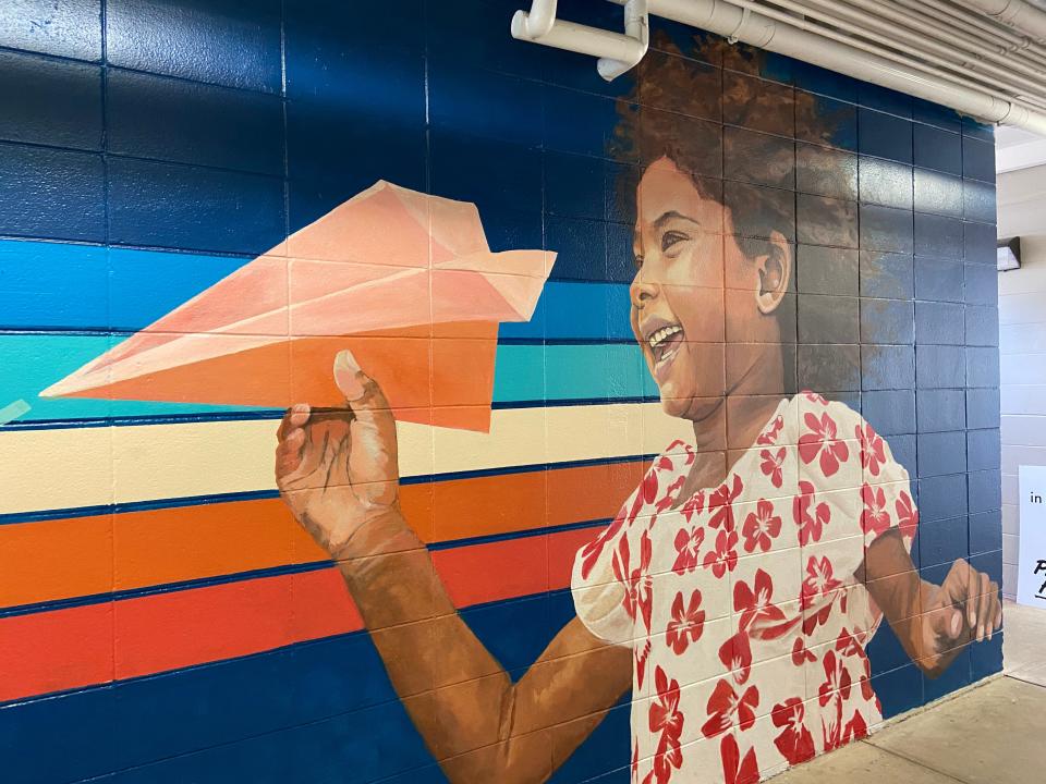The new mural unveiled at Sabal Palm Elementary on Aug. 2, 2023, features a young girl throwing a paper airplane – an homage to Sabal Palm’s history as an airfield before it was developed as an elementary school.
