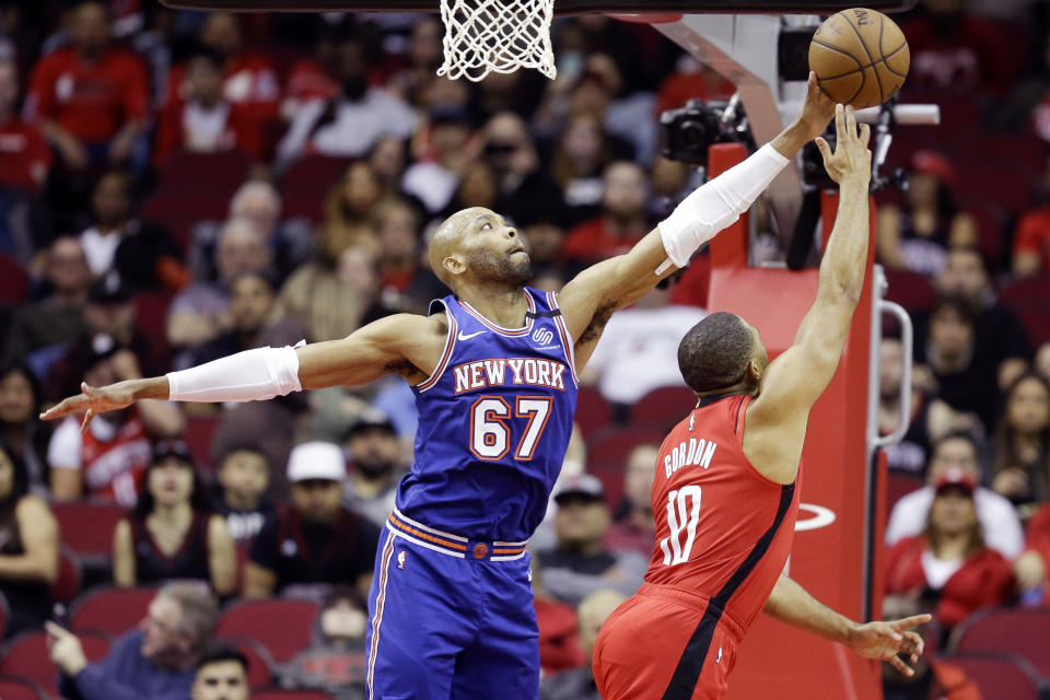 New York Knicks center Taj Gibson (67) blocks the shot of Houston Rockets guard Eric Gordon during the first half of an NBA basketball game, Monday, Feb. 24, 2020, in Houston. (AP Photo/Eric Christian Smith)