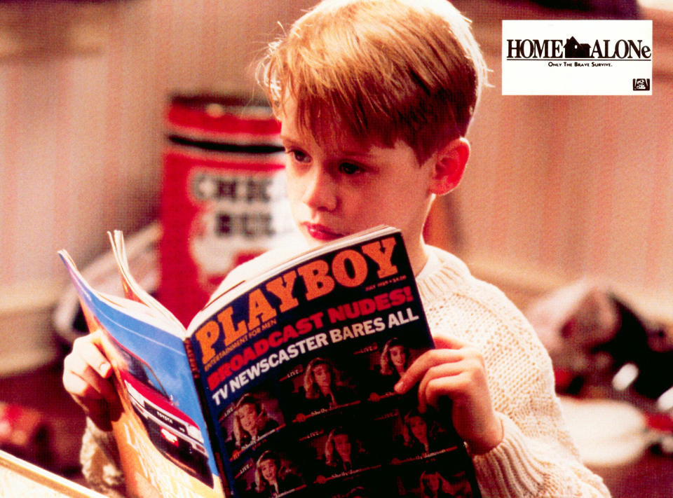 Child actor in "Home Alone" looks at a magazine. The scene invokes a classic moment from the film