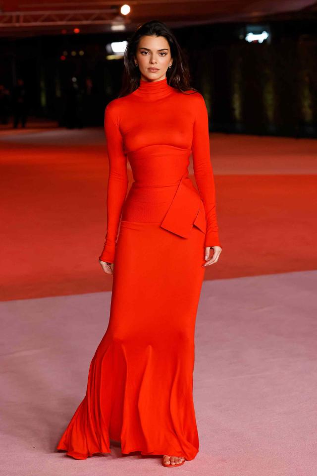 Kendall Jenner Put a Sexy Spin on Holiday Dressing in a Red Semi-Sheer Gown  With No Bra