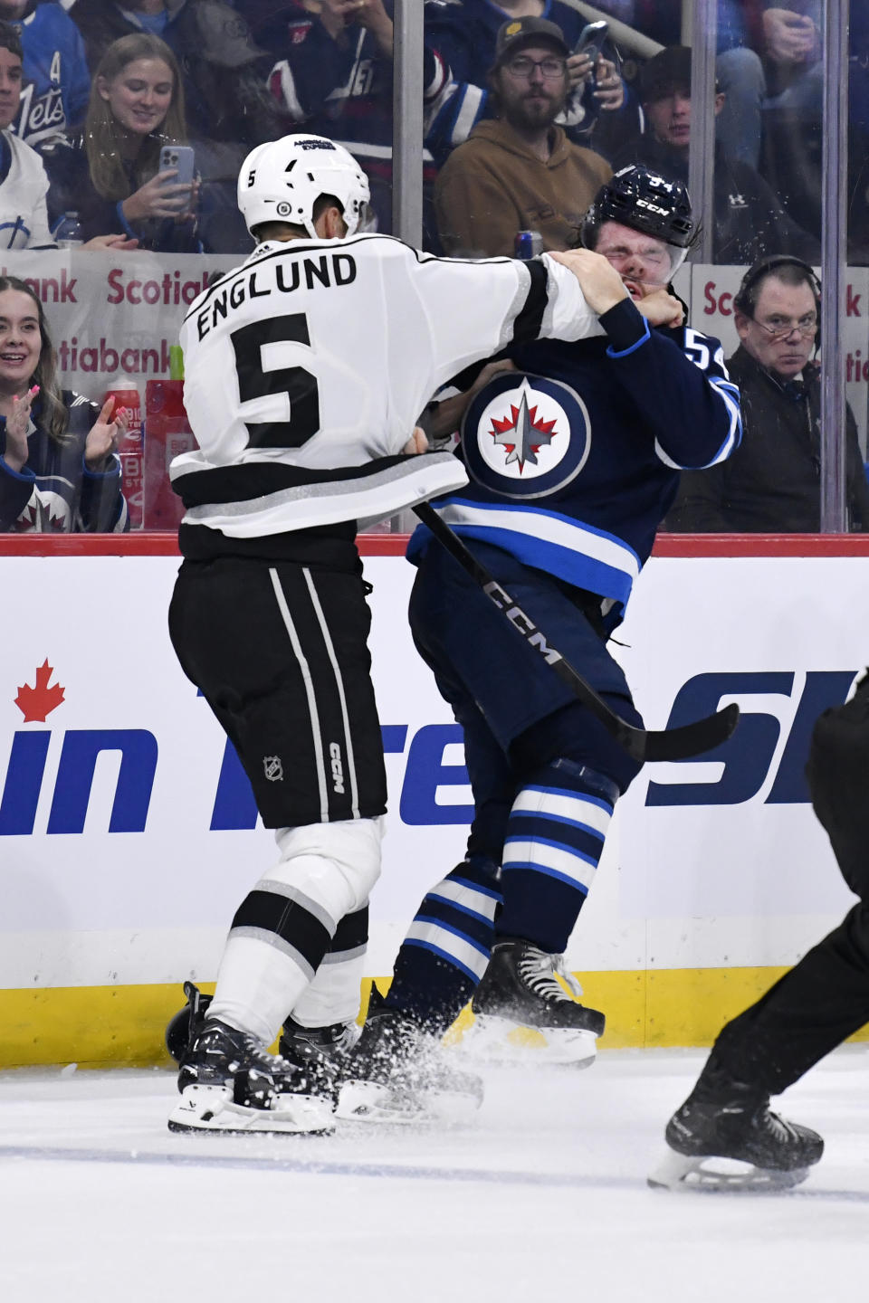 Los Angeles Kings' Andreas Englund (5) fights with Winnipeg Jets' Dylan Samberg (54) during the second period of an NHL hockey game, Tuesday, Oct. 17, 2023 in Winnipeg, Manitoba. (Fred Greenslade/The Canadian Press via AP)