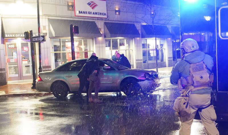 Members of the United States Secret Service react to a vehicle crashing into a Secret Service SUV that was blocking the street, in Wilmington