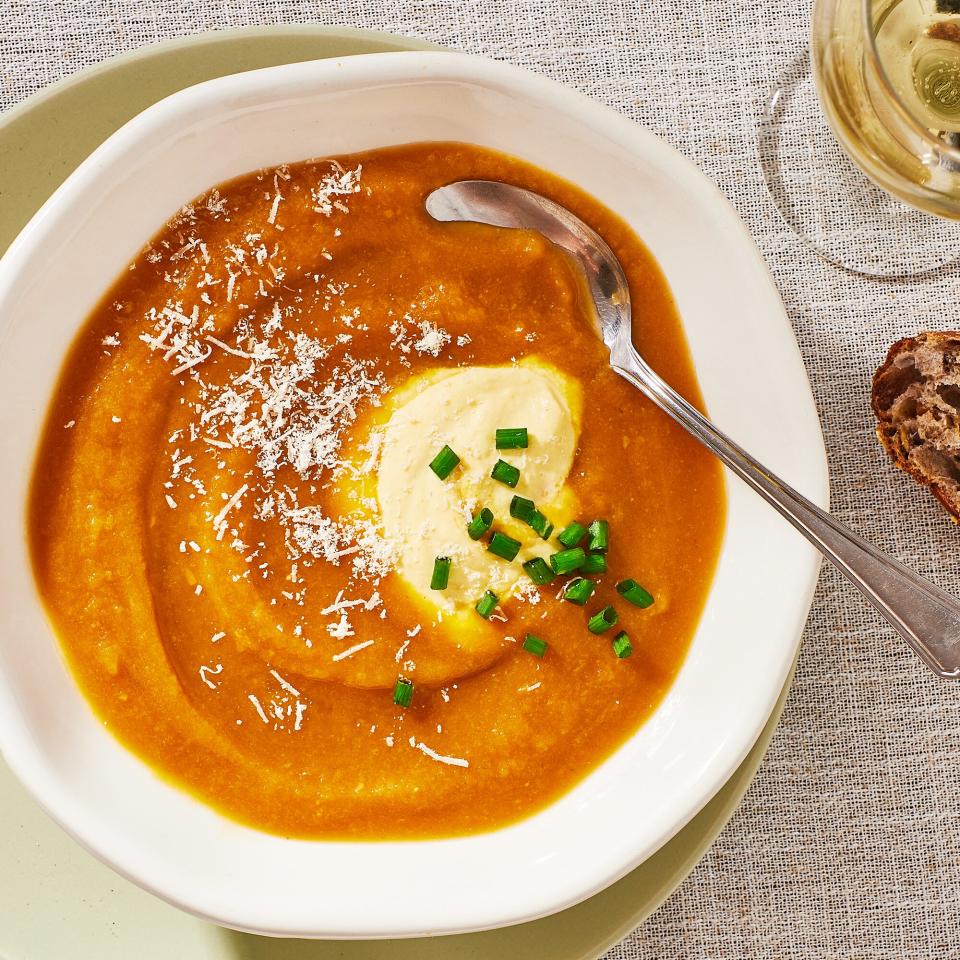 a recipe photo of the Velvety Winter Squash Soup with Smoky Garlic Custard served in a bowl