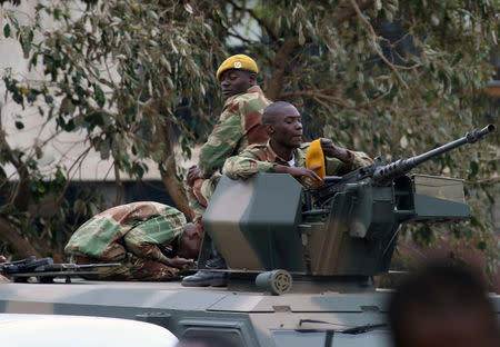 Soldiers stand guard on armoured vehicles on the streets of Harare, Zimbabwe November 19, 2017. REUTERS/Philimon Bulawayo