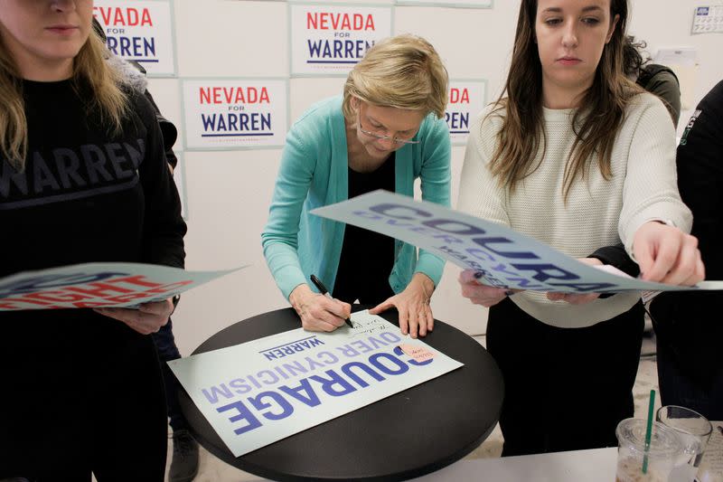 U.S. Democratic presidential candidate Senator Elizabeth Warren autographs a sign for a supporter as she holds a "Canvass Kickoff" event at her campaign field office in North Las Vegas