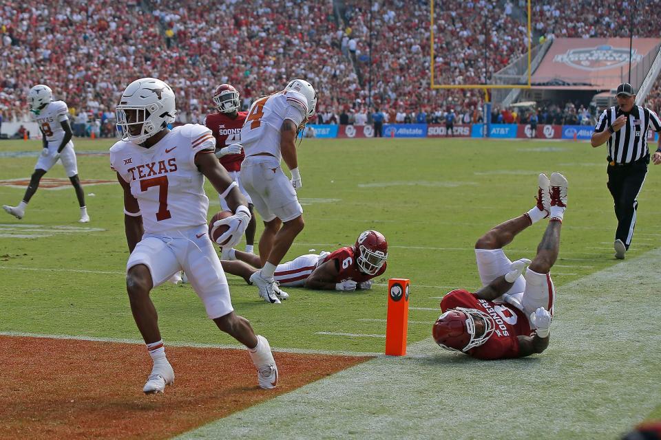 Texas running back Keilan Robinson scores on a 15-yard touchdown catch in the second quarter of last week's win over Oklahoma. On Monday, Longhorns coach Steve Sarkisian praised the blocking of wide receivers Jordan Whittington, back, and Xavier Worthy on the play.