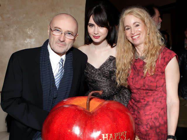 <p>Todd Williamson/Getty</p> Phil Collins, Lily Collins and Jill Tavelman in 2012