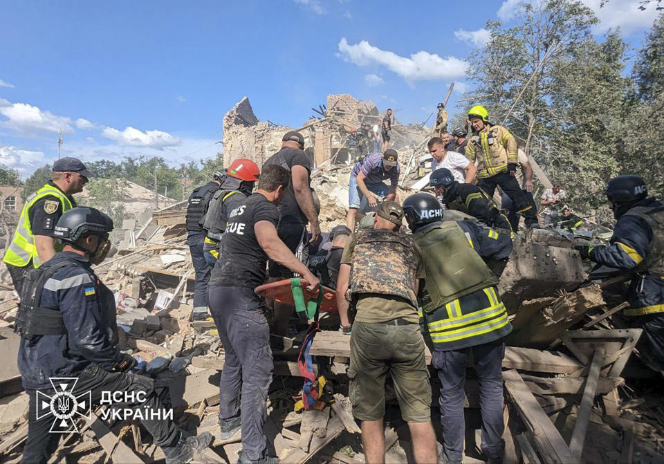 In this photo provided by the Ukrainian Emergency Service, emergency workers clear the rubble as they search for victims after a Russian missile hit the area, in Kryvyi Rih, Ukraine, Wednesday, June 12, 2024. (Ukrainian Emergency Service via AP)