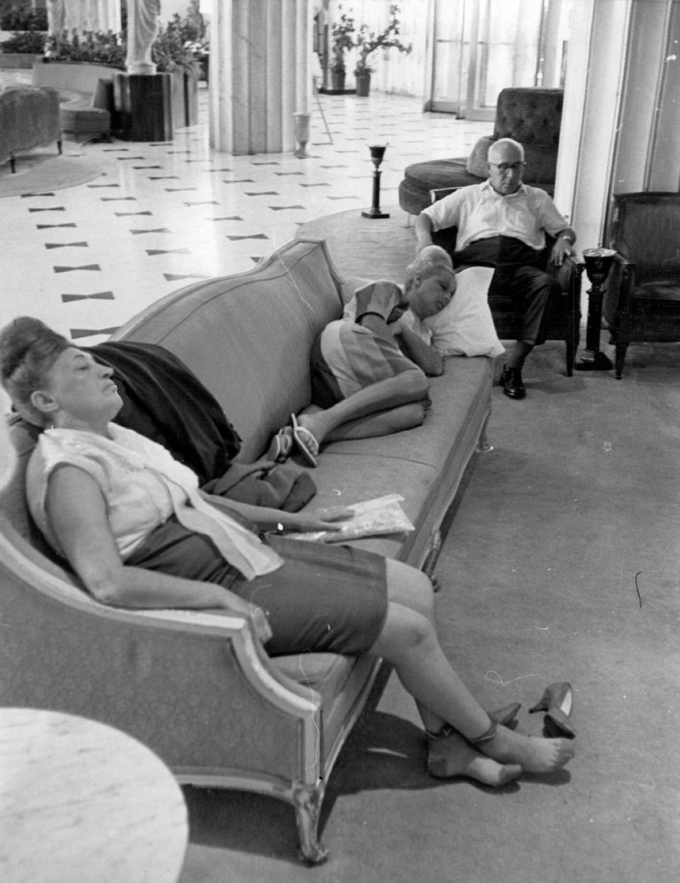 Weary hotel dwellers nap in Fontainebleau lobby after Hurricane Cleo in 1964.