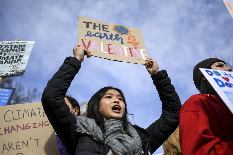 Children gather at Parliament Square holding placards and flags, as they protest against climate change, in London, Friday, Feb. 14, 2020.(AP Photo/Alberto Pezzali)