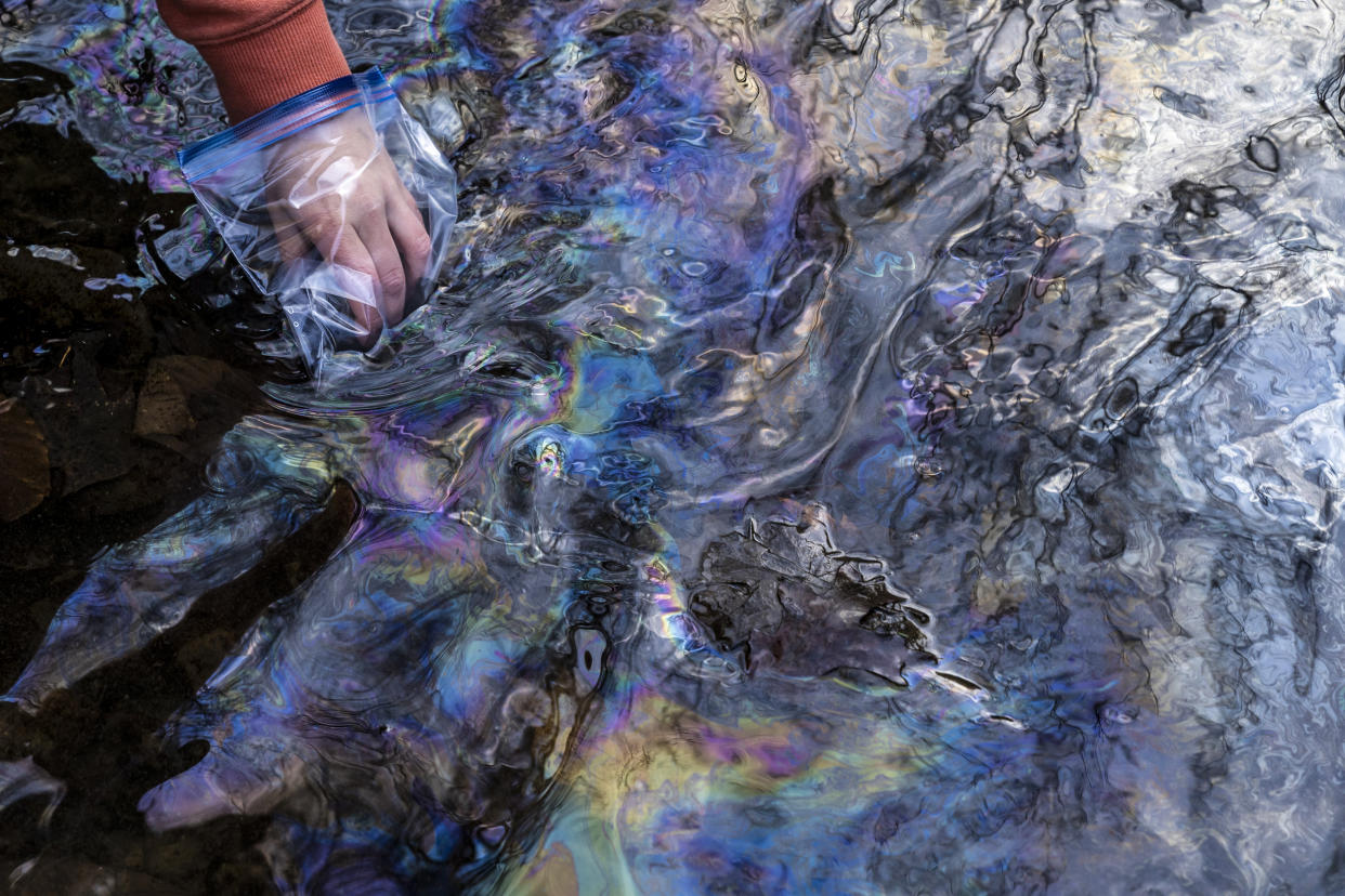 Image: Olivia Holley, 22, and Taylor Gulish, 22, collect water samples from Leslie Run creek on February 25, 2023 in East Palestine, Ohio. Holley and Gulish are testing the pH and the total dissolved solids (TDS) of the water. (Michael Swensen / Getty Images file)