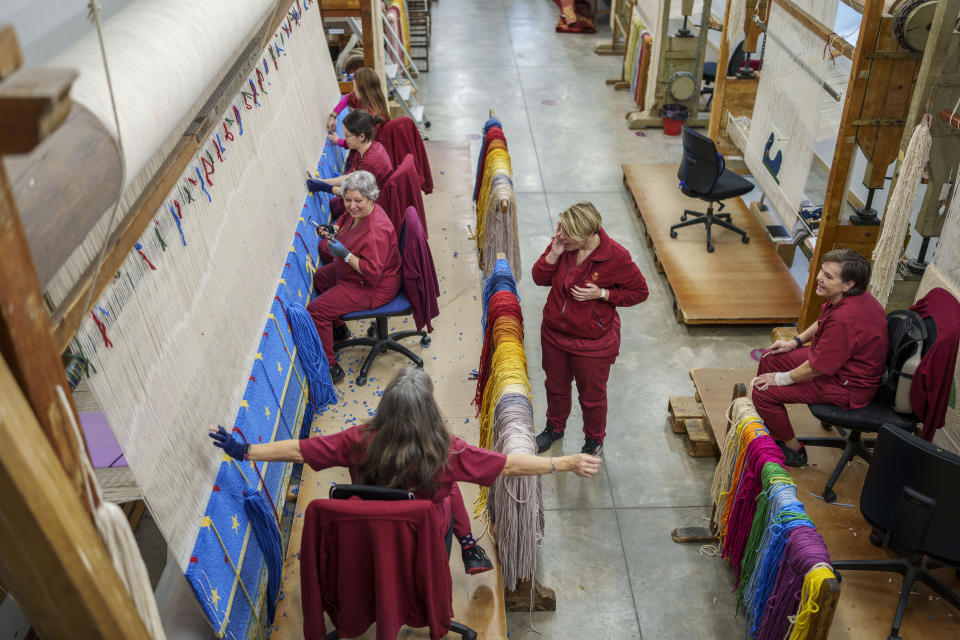 Craftswomen work at the Royal Tapestry Factory in Madrid, Spain, Friday, Nov. 30, 2023. Since its foundation in 1721, the Royal Tapestry Factory of Madrid has not stopped producing. It was Philip V, then King of Spain, who had the factory built with the help of Catholic craftsmen from Flanders to replace the lack of private initiative that existed at the time. (AP Photo/Manu Fernandez)