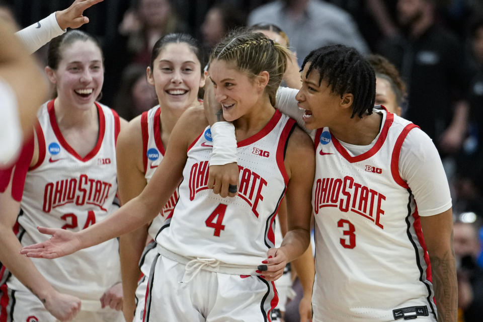 Ohio State guard Jacy Sheldon (4) is hugged by guard Hevynne Bristow (3) after Ohio State defeated North Carolina in a second-round college basketball game in the women's NCAA Tournament in Columbus, Ohio, Monday, March 20, 2023. Ohio State defeated North Carolina 71-69. (AP Photo/Michael Conroy)