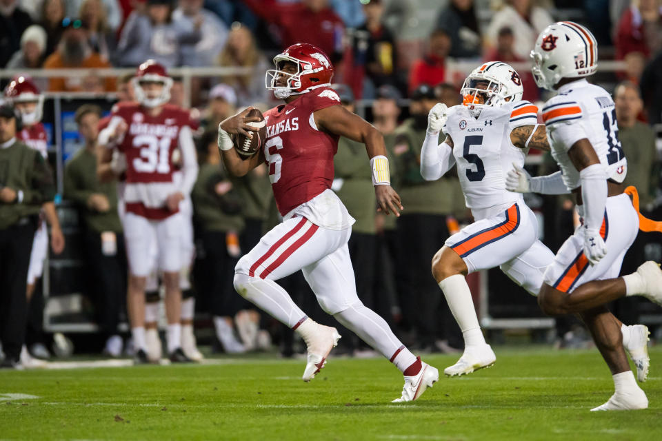 Nov 11, 2023; Fayetteville, Arkansas, USA; Arkansas Razorbacks quarterback Jacolby Criswell (6) runs for a large gain as Auburn Tigers safety Donovan Kaufman (5) and linebacker Cam Riley (13) pursue him during the fourth quarter at Donald W. Reynolds Razorback Stadium. Auburn won 48-10. Mandatory Credit: Brett Rojo-USA TODAY Sports