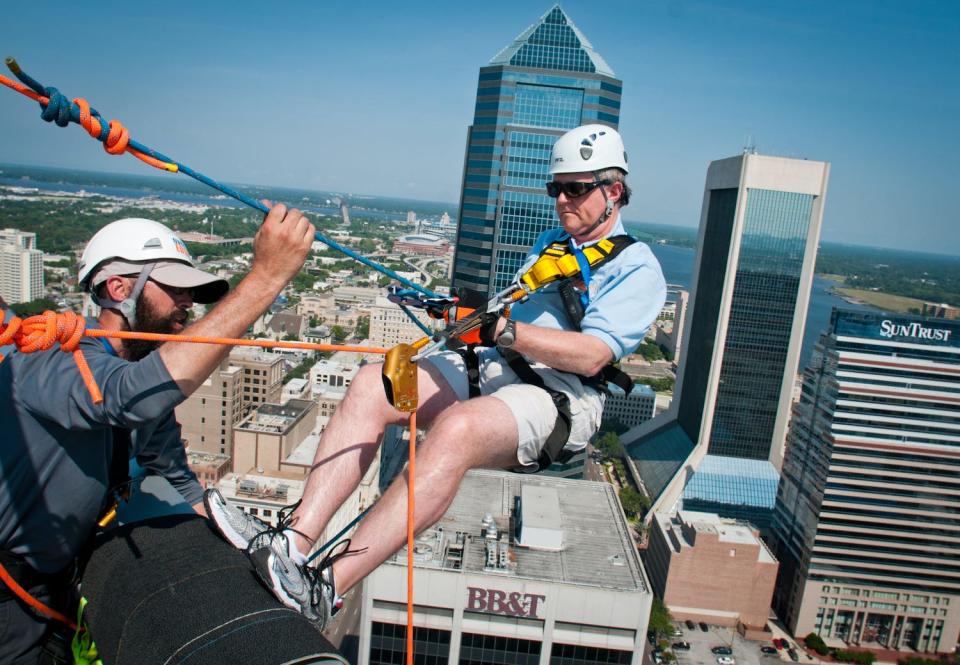 Jack Sears, CEO of the Boy Scouts of America North Florida Council, starts his 450-feet descent rappelling down the 30-story side of the AT&T Tower during the 2011 Over The Edge event. The 58 participants had to raise at least $1,000 in pledges to take on the challenge; proceeds went to the council.