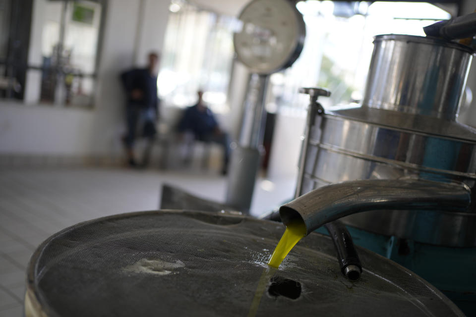 A tank is filled with olive at an olive mill in Spata suburb, east of Athens, Greece, Monday, Oct. 23, 2023. Across the Mediterranean, warm winters, massive floods, and forest fires are hurting a tradition that has thrived for centuries. Olive oil production has been hammered by the effects of climate change, causing a surge in prices for southern Europe's healthy staple. (AP Photo/Thanassis Stavrakis)