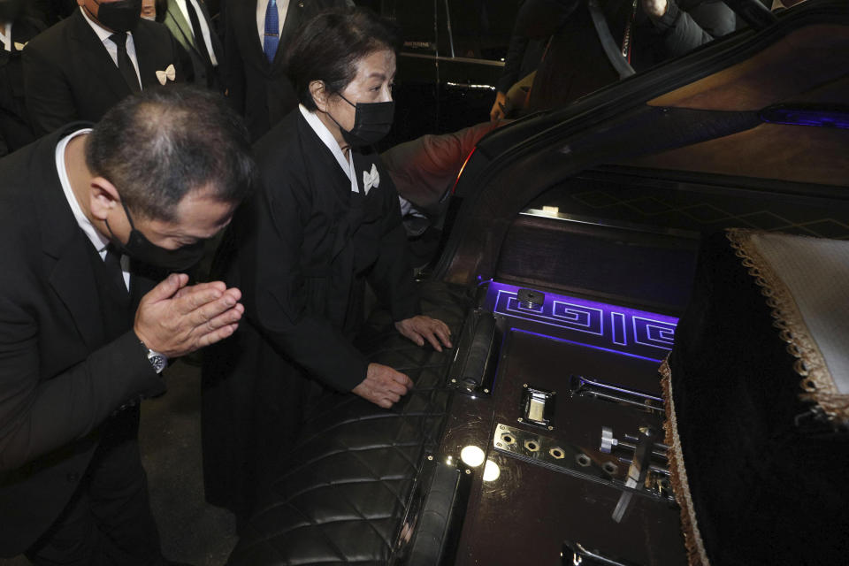 Lee Soon-ja, second from right, the wife of the late former South Korean President Chun Doo-hwan, watches the coffin containing the body of her husband at a funeral hall in Seoul, South Korea, Saturday, Nov. 27, 2021. Former South Korean military strongman Chun, who crushed pro-democracy demonstrations in 1980, died on Tuesday. He was 90. (Korea Pool via AP)