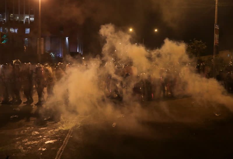 Police are seen amidst tear gas during protests following the impeachment of President Martin Vizcarra, in Lima