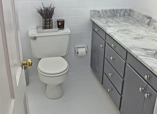 <body> <p>Rather than going through the labor-intensive process of ripping out and replacing the wall and floor tiles, this thrifty blogger had them <a rel="nofollow noopener" href=" http://www.bobvila.com/articles/how-to-paint-tile/?bv=yahoo" target="_blank" data-ylk="slk:painted;elm:context_link;itc:0;sec:content-canvas" class="link ">painted</a>, lightening and updating the room's ambience. Echoing the new sleek design, the vanity got a paint job as well as a new countertop—but one that incurred minimal effort and expense: This pristine marble slab came from the remnant yard of a local granite fabricator.</p> <p><strong>Related: <a rel="nofollow noopener" href=" http://www.bobvila.com/articles/3710-granite-countertops-a-buyer-s-guide/#.Va-xlipViko?bv=yahoo" target="_blank" data-ylk="slk:Buyer’s Guide—Granite Countertops;elm:context_link;itc:0;sec:content-canvas" class="link ">Buyer’s Guide—Granite Countertops</a> </strong> </p> </body>