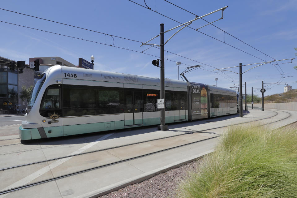 A light rail train runs through downtown Tempe, Ariz., Monday, Aug. 26, 2019. The latest numbers on mail-in ballots are expected Monday after the weekend for Tuesday's special election weighing any future expansion to the light rail system in Phoenix, the nation's fifth largest city. (AP Photo/Matt York)