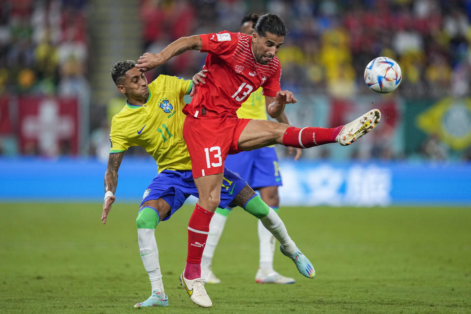 Switzerland's Ricardo Rodriguez, right, vies for the ball with Brazil's Raphinha during the World Cup group G soccer match between Brazil and Switzerland, at the Stadium 974 in Doha, Qatar, Monday, Nov. 28, 2022. (AP Photo/Ariel Schalit)