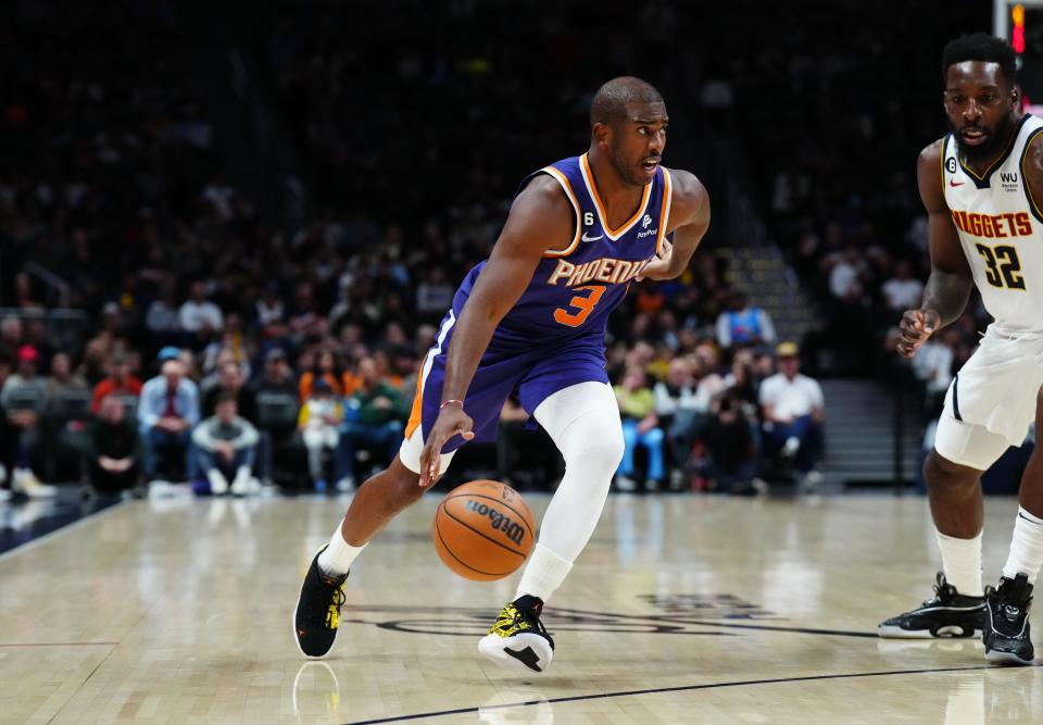 Oct 10, 2022; Denver, Colorado, USA; Phoenix Suns guard Chris Paul (3) drives to the basket in the second quarter against the Denver Nuggets at Ball Arena.