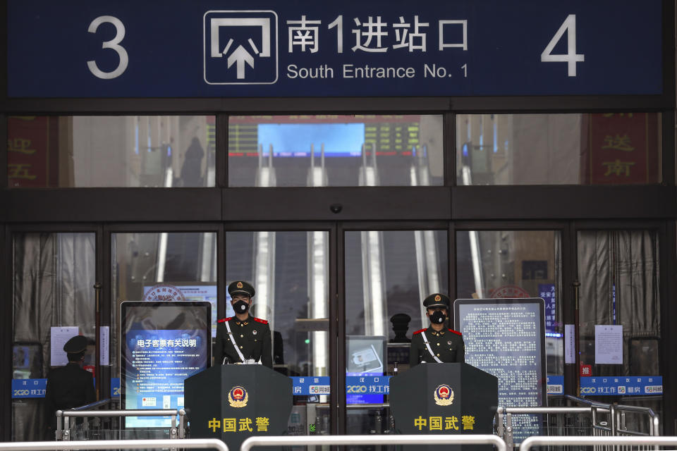 Chinese paramilitary police stand guard outside the closed Hankou Railway Station in Wuhan in central China's Hubei Province, Thursday, Jan. 23, 2020. Overnight, Wuhan authorities announced that the airport and train stations would be closed, and all public transportation suspended by 10 a.m. Friday. Unless they had a special reason, the government said, residents should not leave Wuhan, the sprawling central Chinese city of 11 million that's the epicenter of an epidemic that has infected nearly 600 people. (Chinatopix via AP)