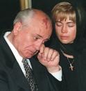 FILE - Former Soviet president Mikhail Gorbachev wipes away tears next to his daughter Irina VIrganskaya during a ceremony for the public to pay their last respects to his wife Raisa Gorbachev in Moscow, Wednesday, September 22, 1999. When Mikhail Gorbachev is buried Saturday at Moscow's Novodevichy Cemetery, he will once again be next to his wife, Raisa, with whom he shared the world stage in a visibly close and loving marriage that was unprecedented for a Soviet leader. Gorbachev's very public devotion to his family broke the stuffy mold of previous Soviet leaders, just as his openness to political reform did. (AP Photo, File)