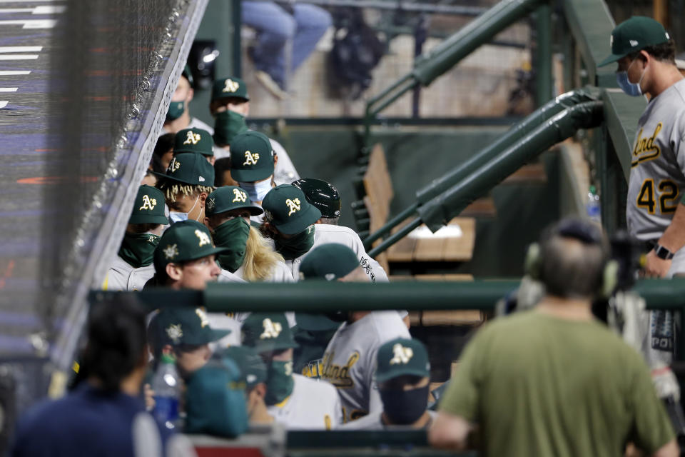 Oakland Athletics players walk out of the dugout in protest of racial injustice before their baseball game against the Houston Astros, Friday, Aug. 28, 2020, in Houston. (AP Photo/Michael Wyke)