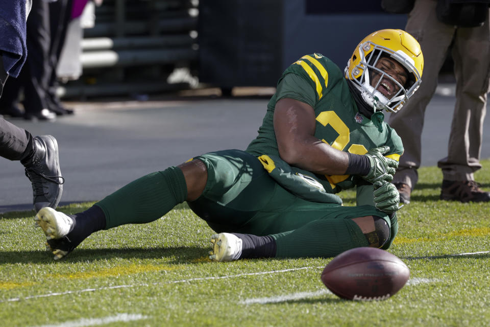 Green Bay Packers running back Emanuel Wilson reacts after going down during the first half of an NFL football game against the Los Angeles Chargers, Sunday, Nov. 19, 2023, in Green Bay, Wis. (AP Photo/Matt Ludtke)