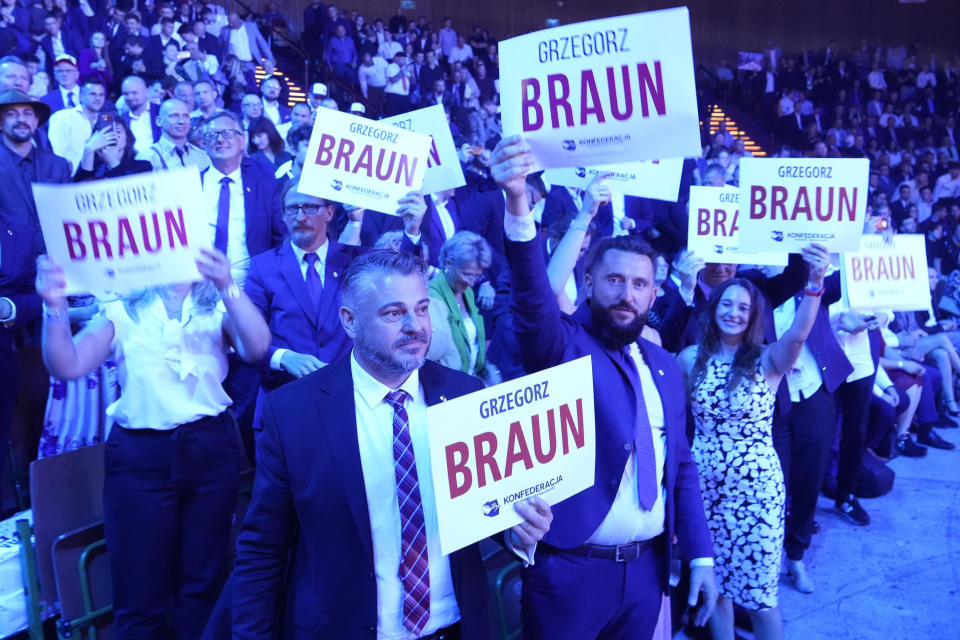 Supporters of the hard right Confederation party hold up cards with the name of candidate Grzegorz Braun in Katowice, Poland, on Saturday, Sept. 23, 2023. Confederation has been growing in popularity, especially among young men. The party has been riding a wave of growing support for far-right parties across Europe, and polls show it could increase its presence in parliament in a national election Oct. 15. No matter how they do on election day, the party has already done a lot to push the government to take a more confrontational stance to Ukraine, which is fighting for its survival against Russia. (AP Photo/Czarek Sokolowski)