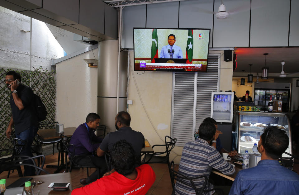 Maldivian watch a live telecast of statement delivered by president Yameen Abdul Gayoom at a cafe in Male, Maldives, Monday, Sept. 24, 2018. Opposition candidate Ibrahim Mohamed Solih declared victory early Monday in the Maldives' contentious presidential election, which was widely seen as a referendum on the island nation's young democracy. Famed for its sandy white beaches and luxury resorts, the nation of islands and atolls in the southern Indian Ocean has seen economic growth and longer life expectancy under strongman President Yameen Abdul Gayoom, according to the World Bank. But democratic freedoms have been curtailed. (AP Photo/Eranga Jayawardena)