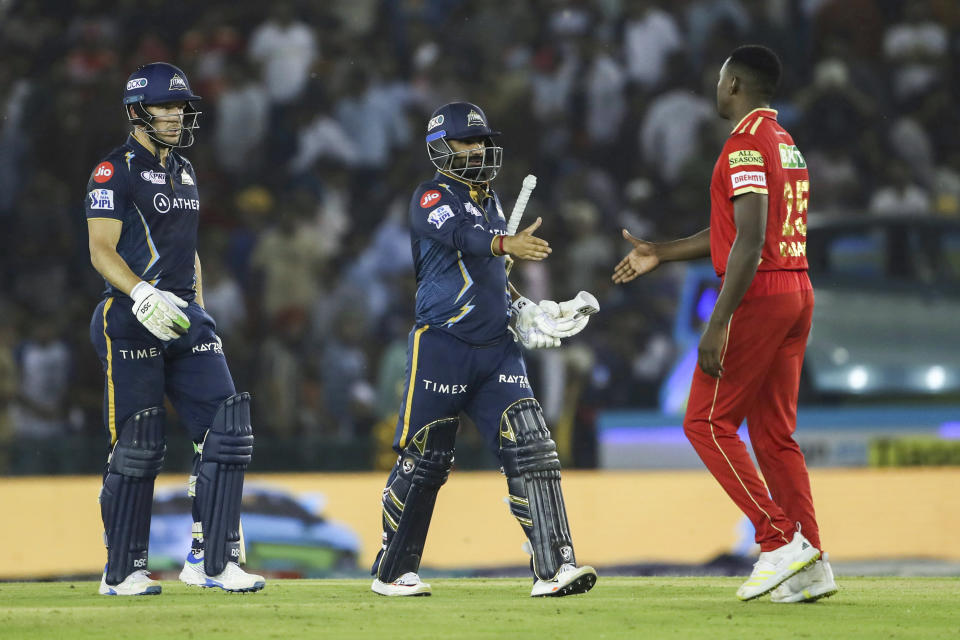 Rahul Tewatia and David Miller of Gujarat Titans left celebrate after winning the Indian Premier League cricket match between Punjab Kings and Gujarat Titans in Mohali, India, Thursday, April 13, 2023. (AP Photo/ Surjeet Yadav)