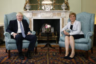 Scotland's First Minister Nicola Sturgeon, right, sits with Britain's Prime Minister Boris Johnson, in Bute House, ahead of their meeting, in Edinburgh, Scotland, Monday July 29, 2019. Johnson made his first official visit as British prime minister to Scotland, pledging to boost "the ties that bind our United Kingdom" amid opposition from Scottish leaders to his insistence on pulling Britain out of the European Union with or without a deal. (Duncan McGlynn/Poo Photo via AP)