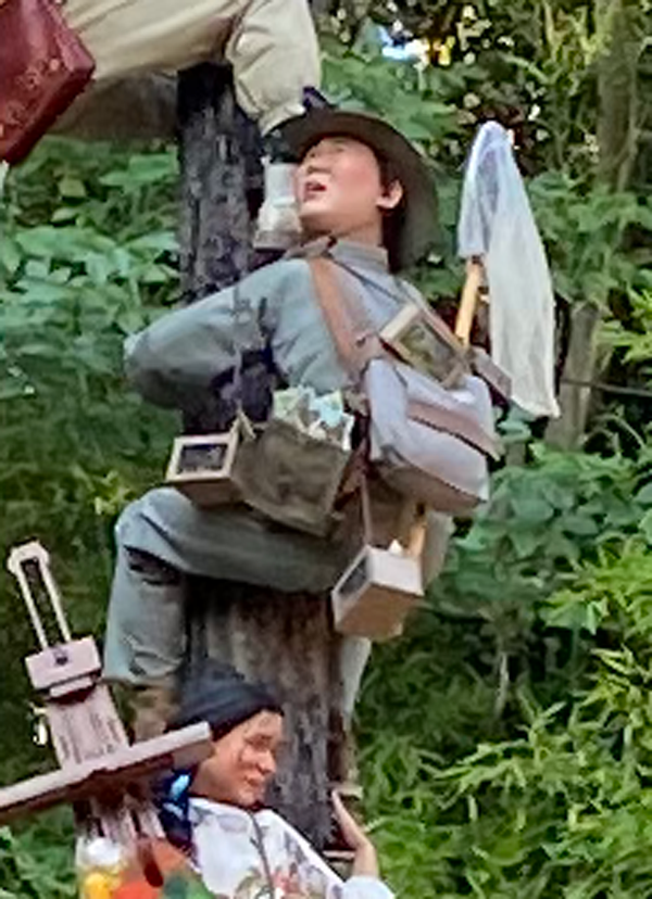 A man with boxes of bugs and a butterfly net