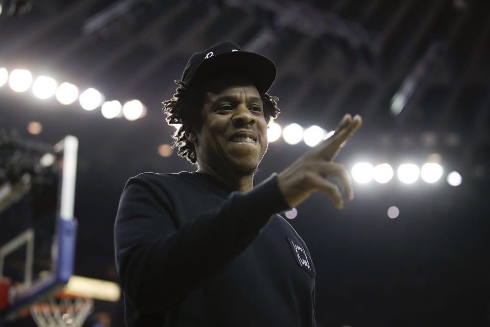 Jay-Z gestures while walking to his seat during the first half of Game 3 of basketball's NBA Finals between the Golden State Warriors and the Toronto Raptors in Oakland, Calif., Wednesday, June 5, 2019. (AP Photo/Ben Margot)