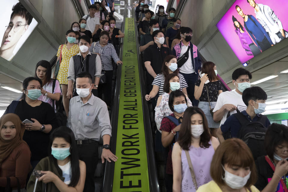 FILE - In this Feb. 7, 2020, file photo, commuters wear face masks to protect themselves from new virus at the skytrain station in Bangkok, Thailand. The virus outbreak that began in China and has spread to more than 20 countries is stretching already-strained public health systems in Asia and beyond, raising questions over whether everyone can get equal access to treatment. (AP Photo/Sakchai Lalit, File)