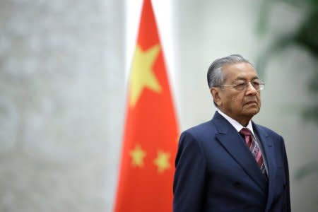 FILE PHOTO: Malaysian Prime Minister Mahathir Mohamad attends a welcome ceremony hosted by China's Premier Li Keqiang at the Great Hall of the People in Beijing, China August 20, 2018. REUTERS/Jason Lee/File Photo