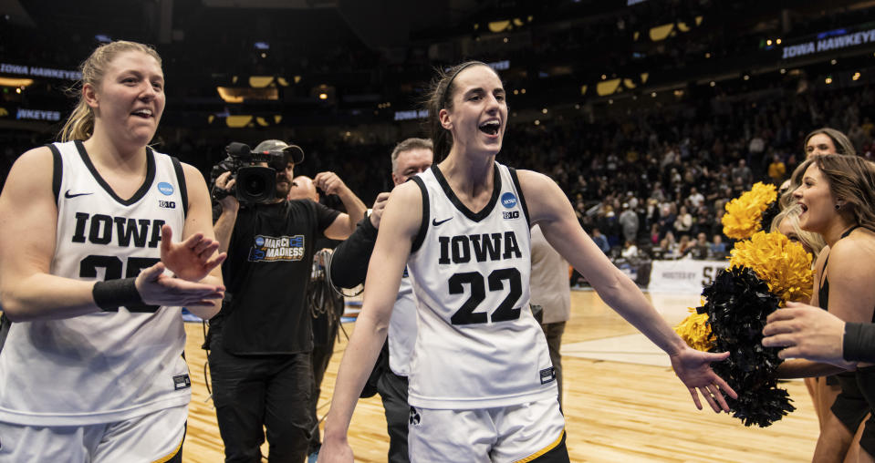 Iowa guard Caitlin Clark (22) and forward Monika Czinano celebrate after a Sweet 16 college basketball game against Colorado in the NCAA tournament, Friday, March 24, 2023, in Seattle. (AP Photo/Stephen Brashear)